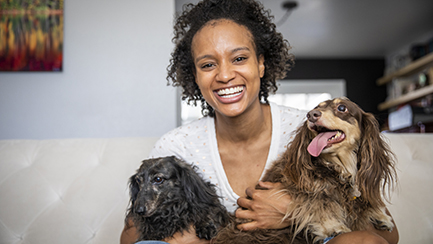 Woman hugging two dogs